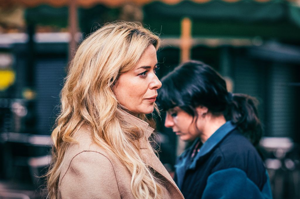 blonde woman standing next to brunette woman