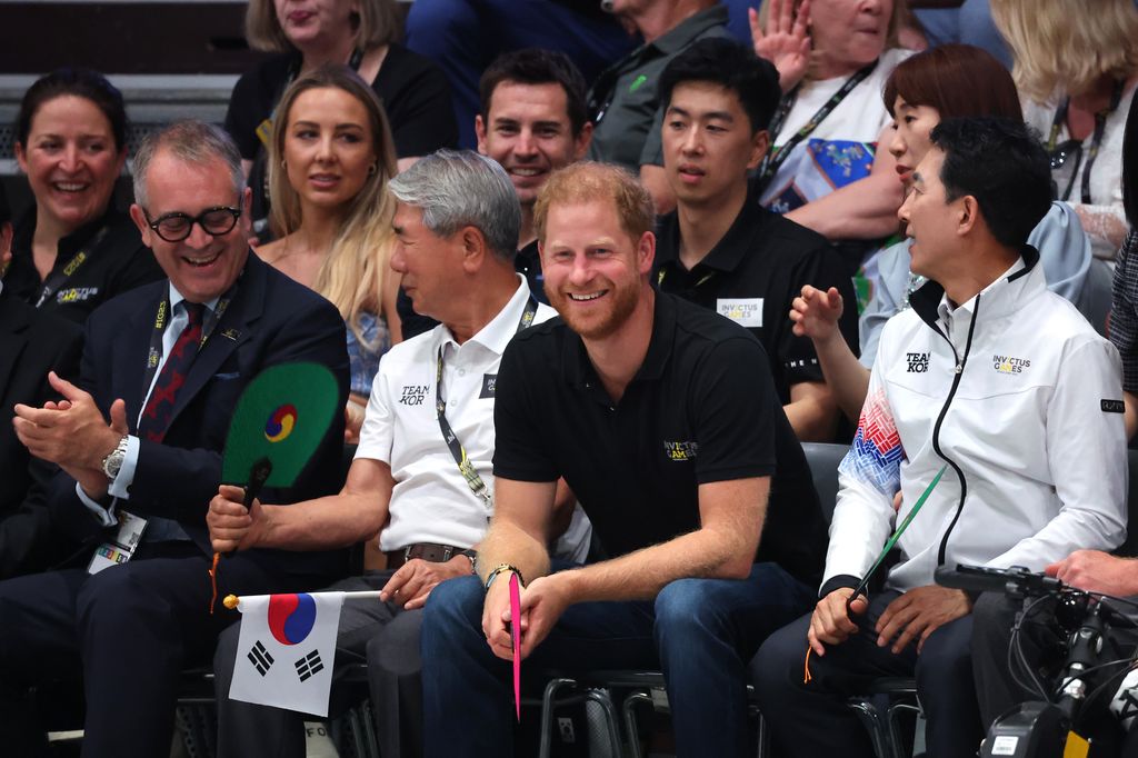 Prince Harry beams as he watches the power lifting on day one of the Invictus Games