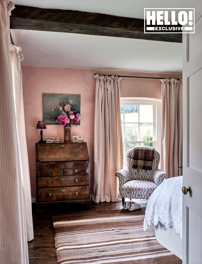 Penelope Chilvers' pink bedroom with striped carpet at Cotswolds home