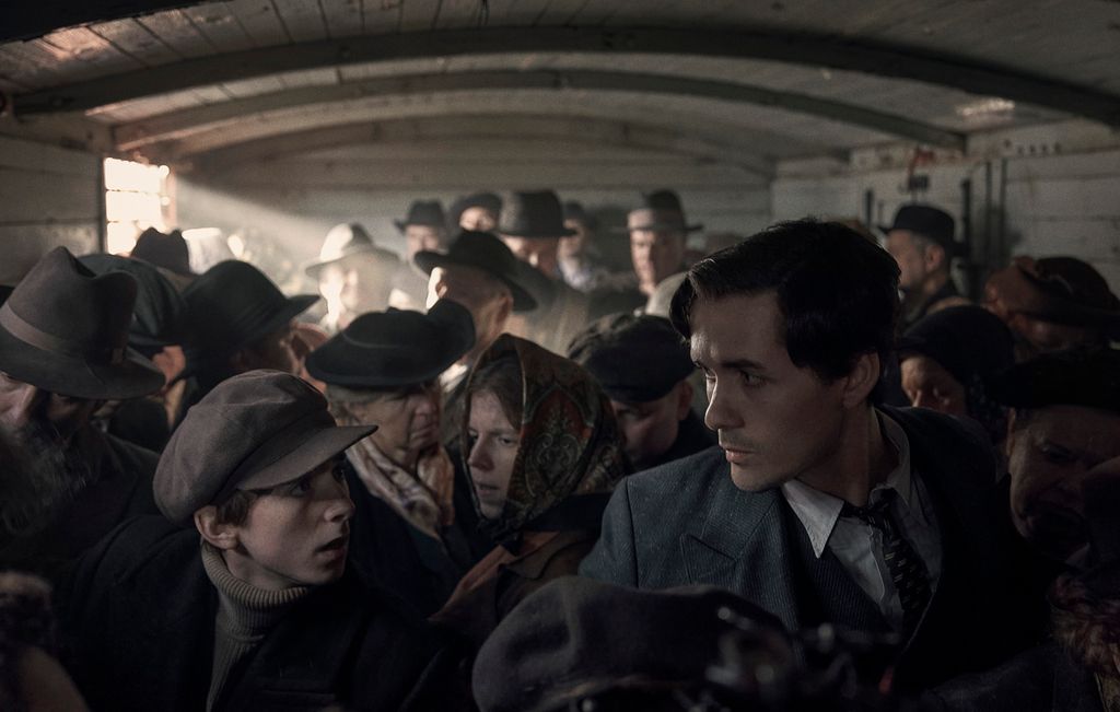 Jonah Hauer-King as Lali Sokolov, seen here as he boards the train to Auschwitz.