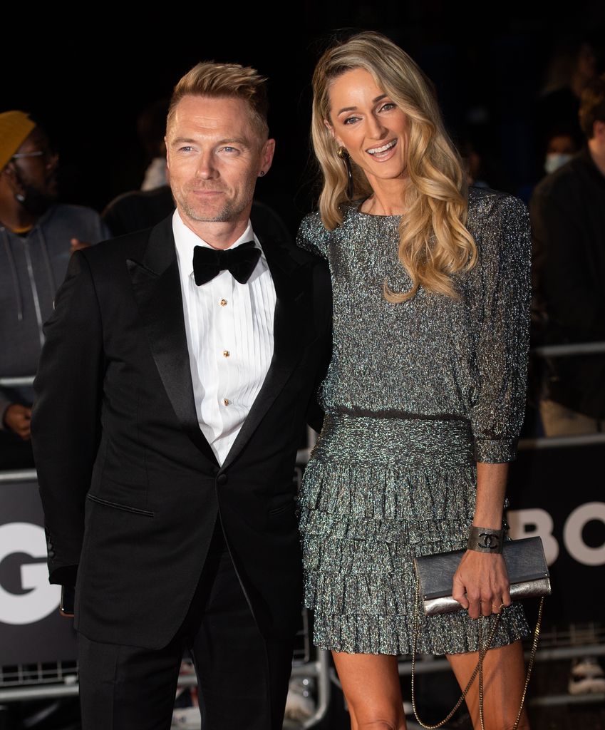 Ronan Keating in suit with Storm Keating in a dress