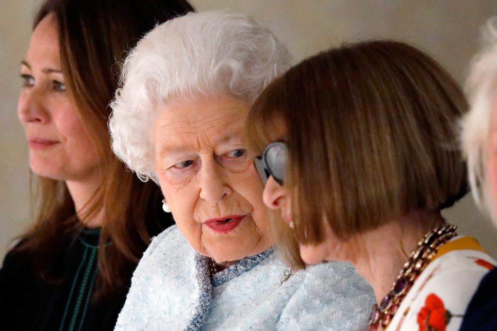 Queen Elizabeth and Anna Wintour chat in the front row at the Richard Quinn London Fashion Week show in February 2018,