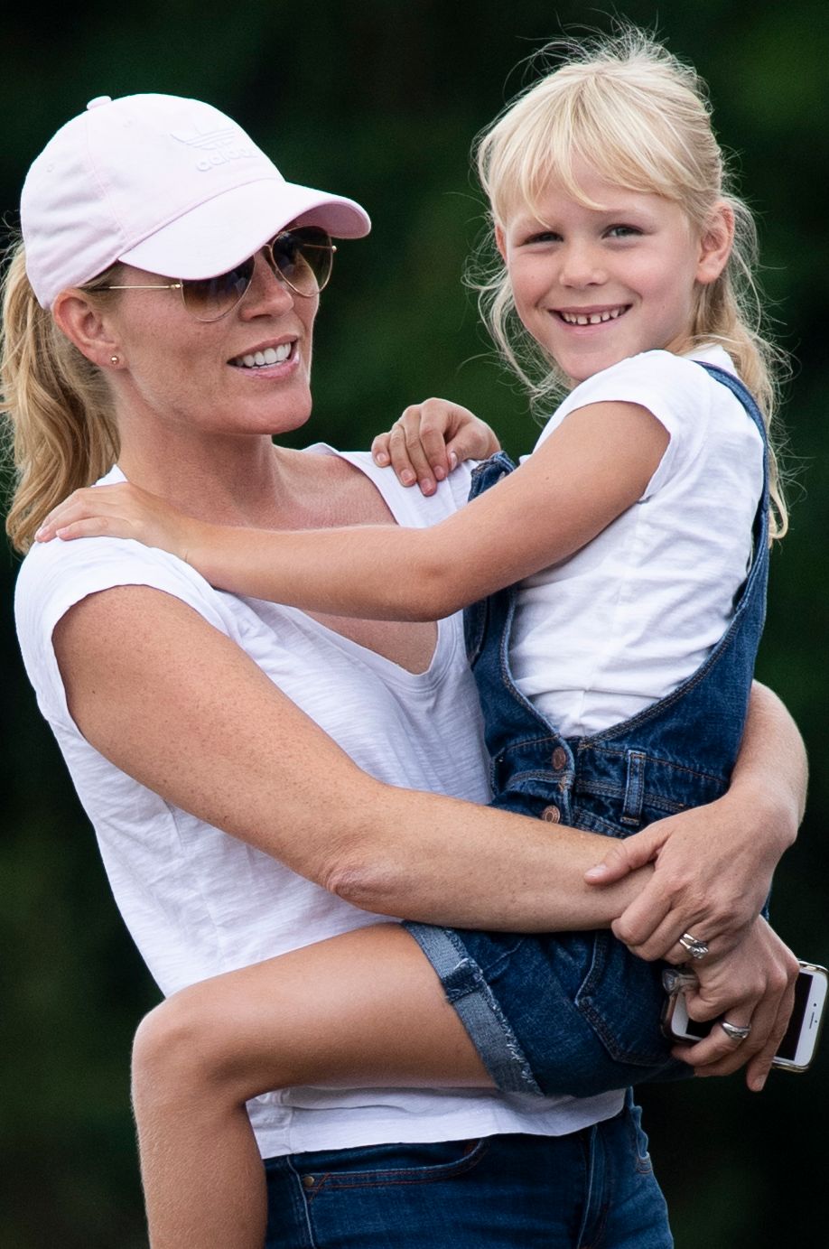 Isla Phillips is carried by her mother Autumn Phillips