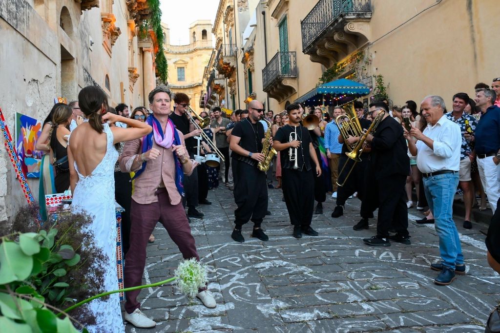 The guests partying with a live marching band on street