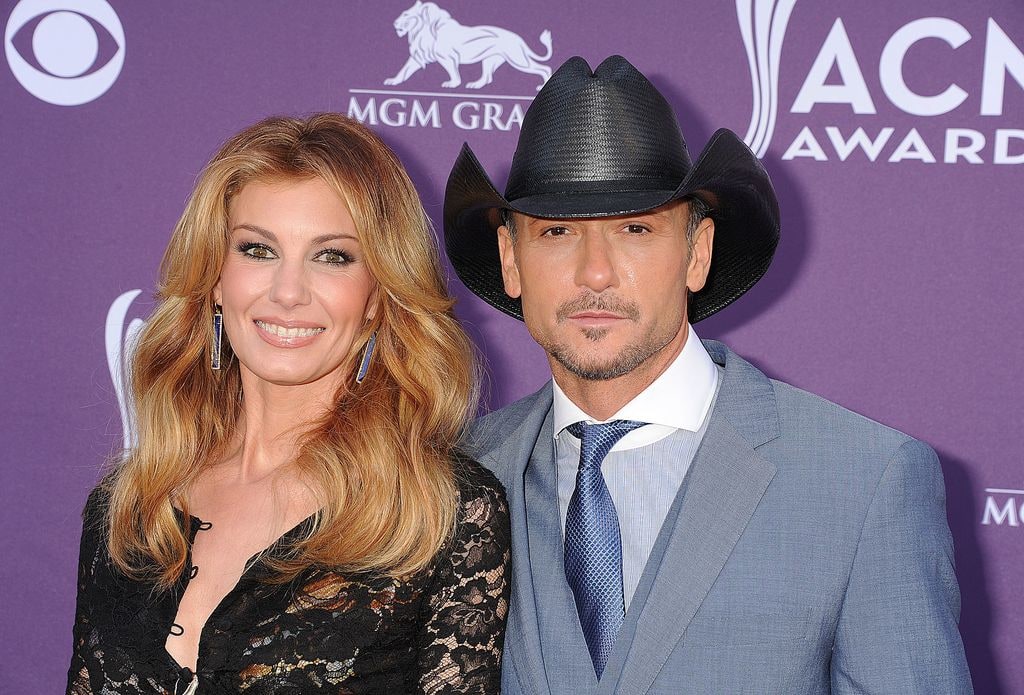 Faith and Tim together red carpet, with Tim wearing a cowboy hat