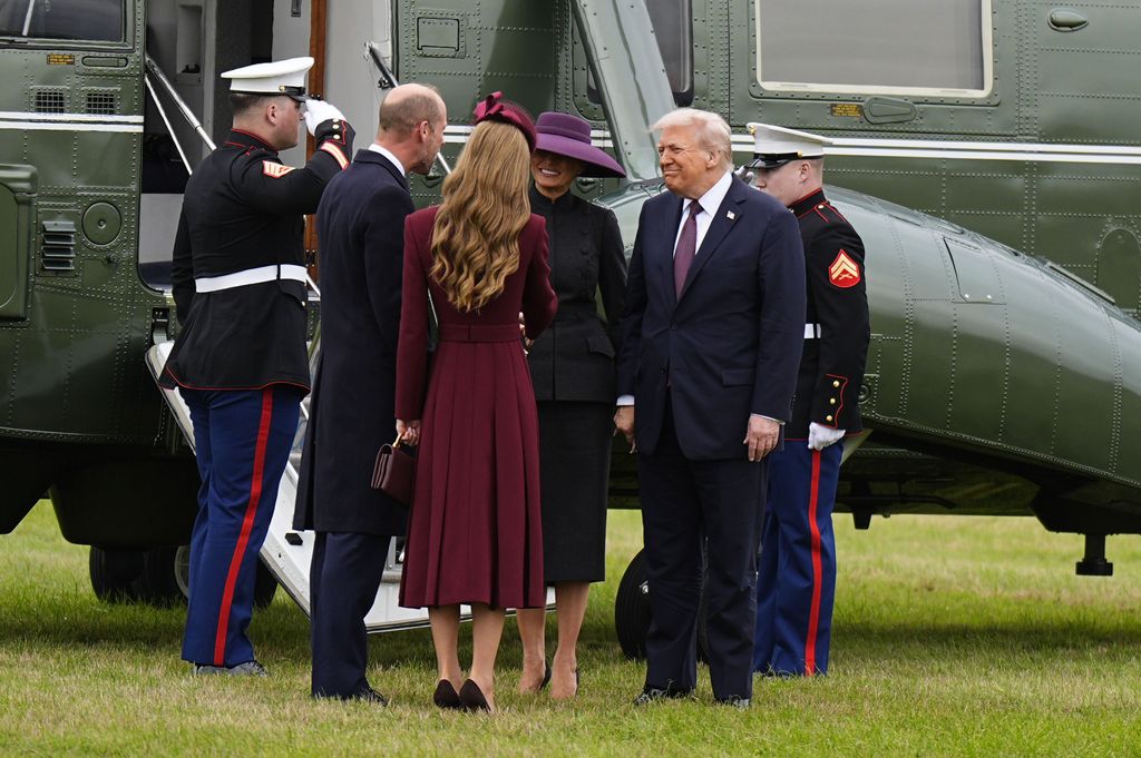 Melania Trump shaking hands with Princess Kate dressed in gray skirt suit