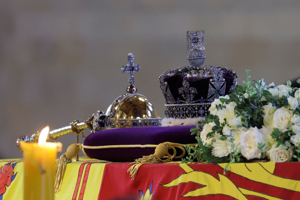 The Imperial State Crown, Sovereign's Orb and Sceptre and flowers resting on the Queen's coffin