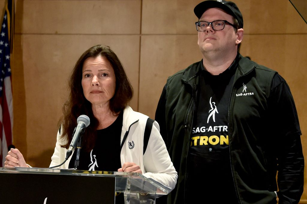 National Executive Director and Chief Negotiator Duncan Crabtree-Ireland as President of SAG-AFTRA, American actress Fran Drescher (left) speaks during a press conference at the union headquarters in Los Angeles Angeles, California on July 13, 2023.