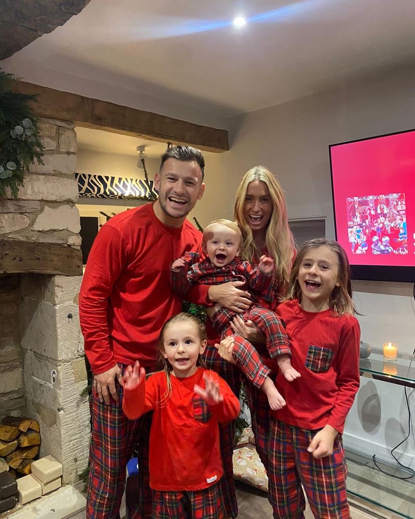 danny with wife and three kids in red xmas pjs