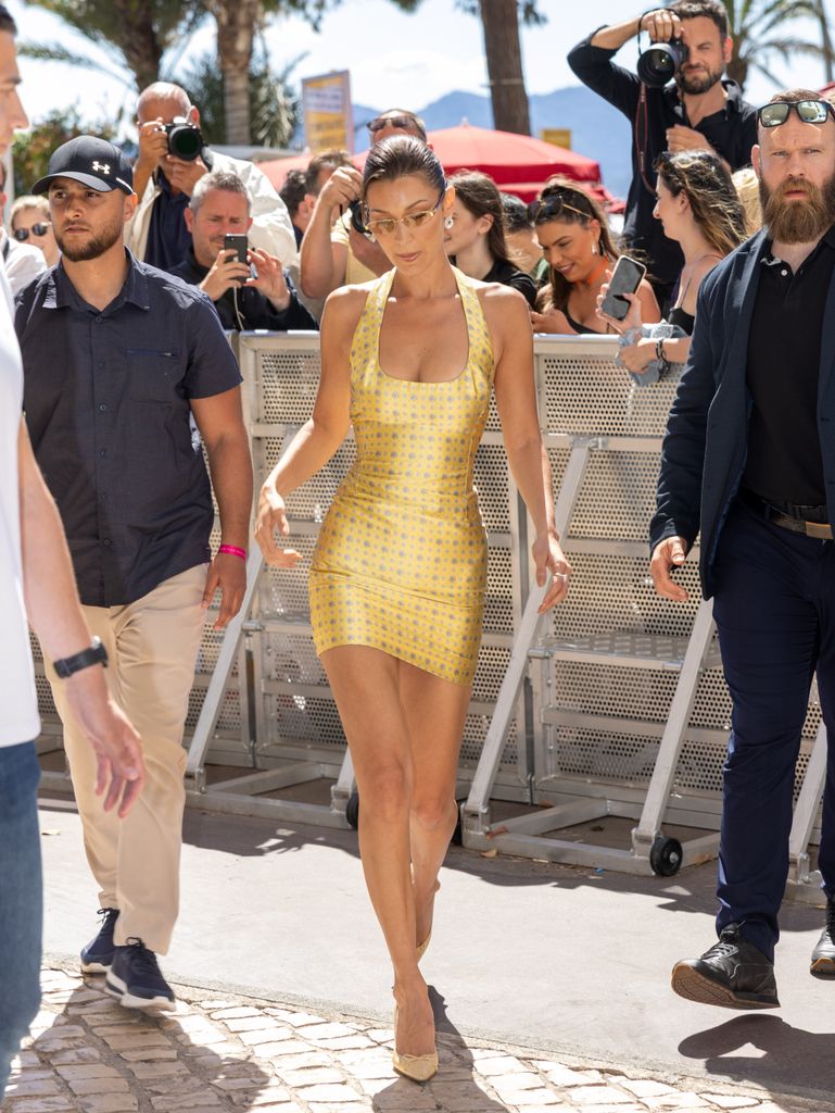 Bella Hadid is seen wearing a gold mini dress in Cannes 