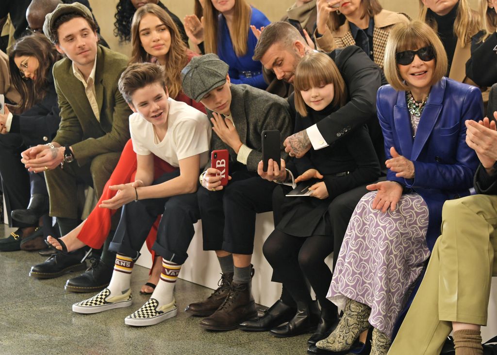 family sat in front row at fashion show