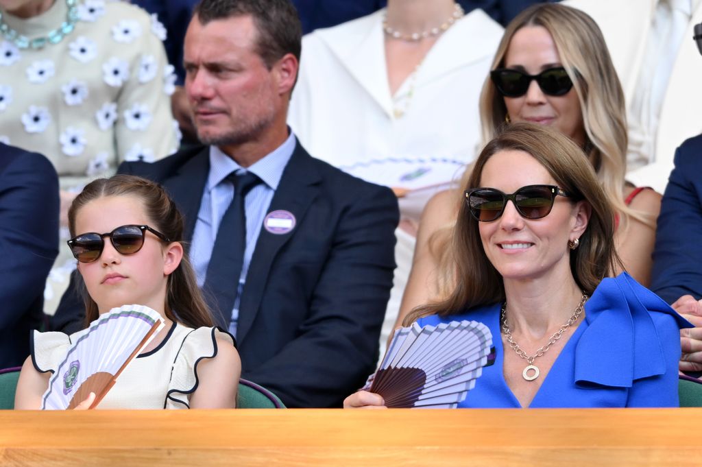 Kate and Charlotte waving fans