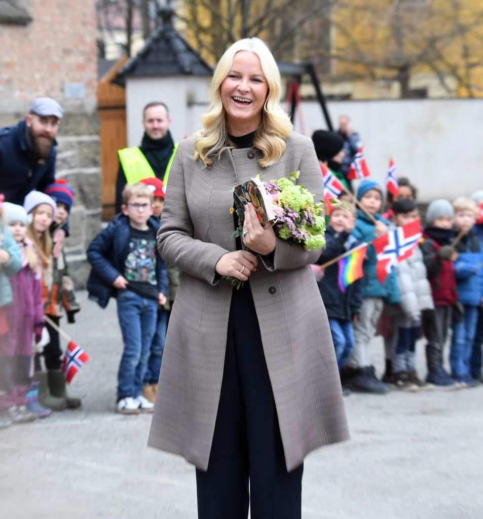 Crown Princess Mette-Marit of Norway smiling in front of crowds of wellwishers