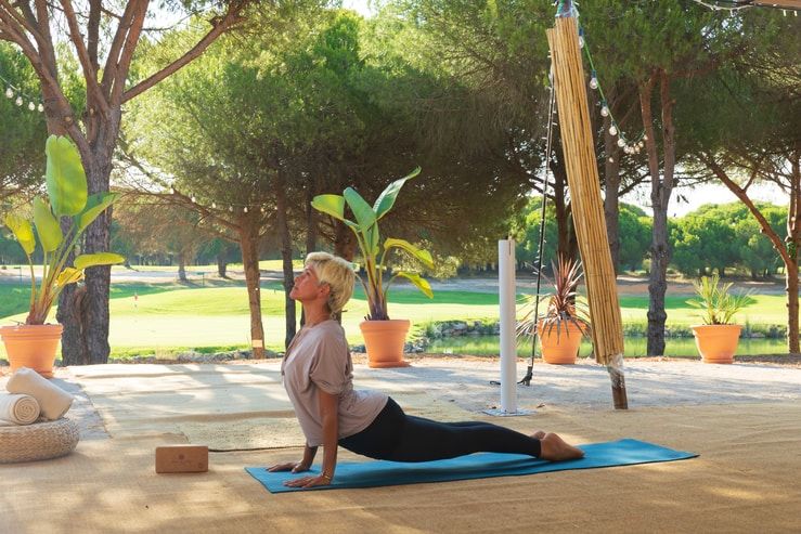 woman doing yoga workout in vale do lobo