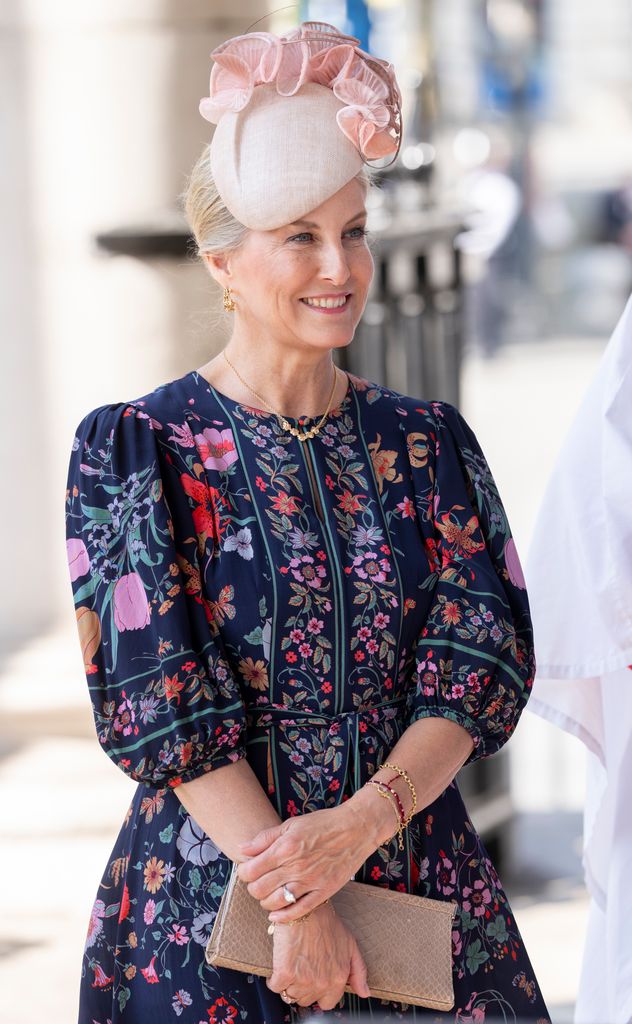 duchess sophie smiling in blue dress and pink hat 