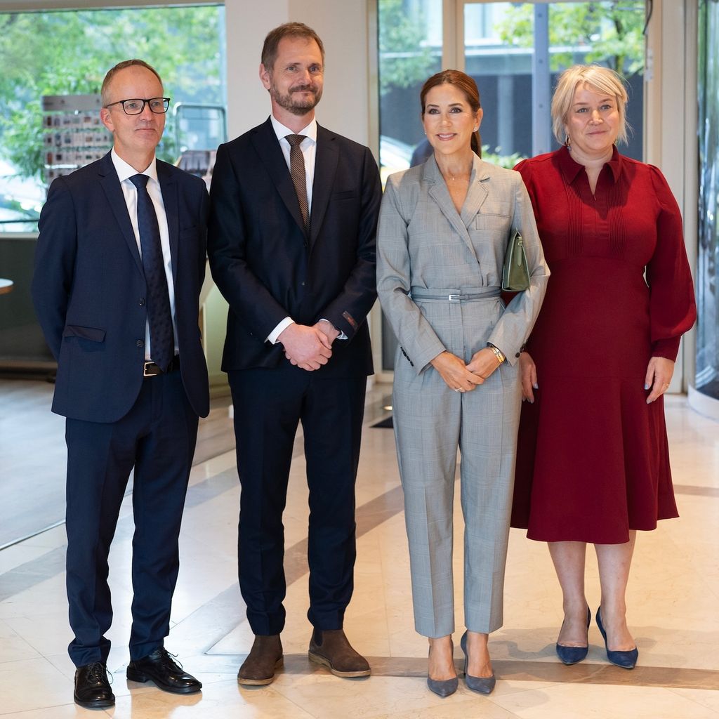 Queen Mary posou com pessoas de macacão