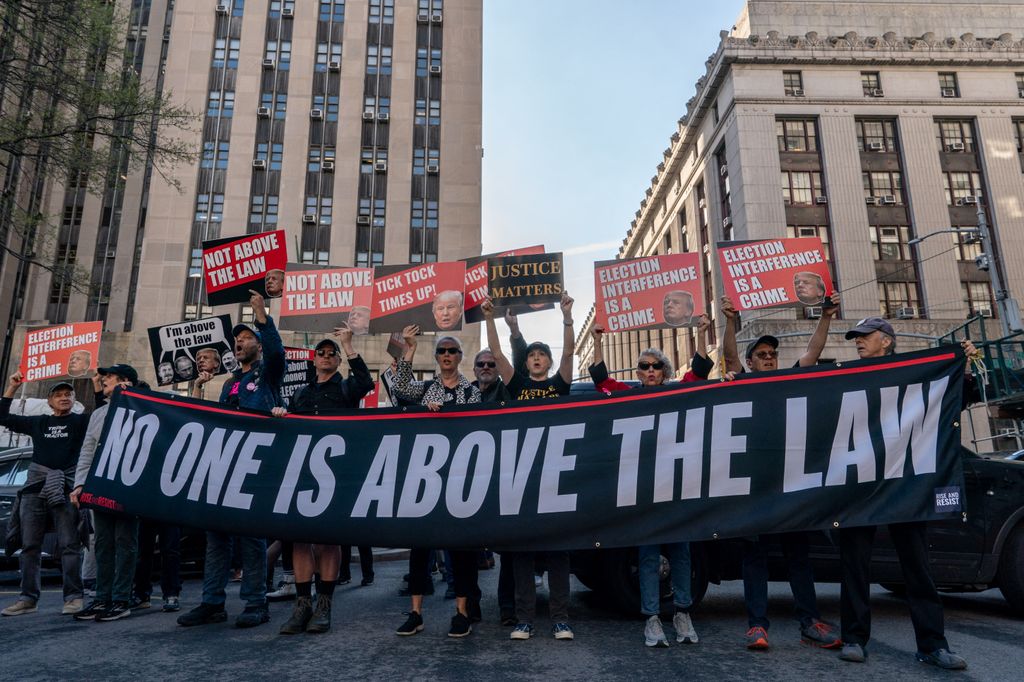 Demonstrators protest outside of Manhattan Criminal Court as former US President Donald Trump attends the first day of his trial for allegedly covering up hush money payments linked to extramarital affairs, in New York City on April 15, 2024. Trump is in court Monday as the first US ex-president ever to be criminally prosecuted, a seismic moment for the United States as the presumptive Republican nominee campaigns to re-take the White House. The scandal-plagued 77-year-old is accused of falsifying business records in a scheme to cover up an alleged sexual encounter with adult film actress Stormy Daniels to shield his 2016 election campaign from adverse publicity