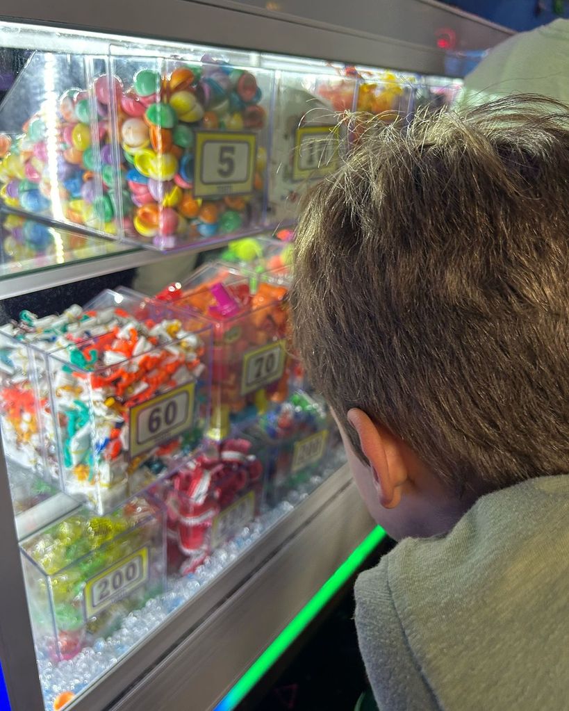 Ginger Zee's son looks inside a case looking for arcade prizes