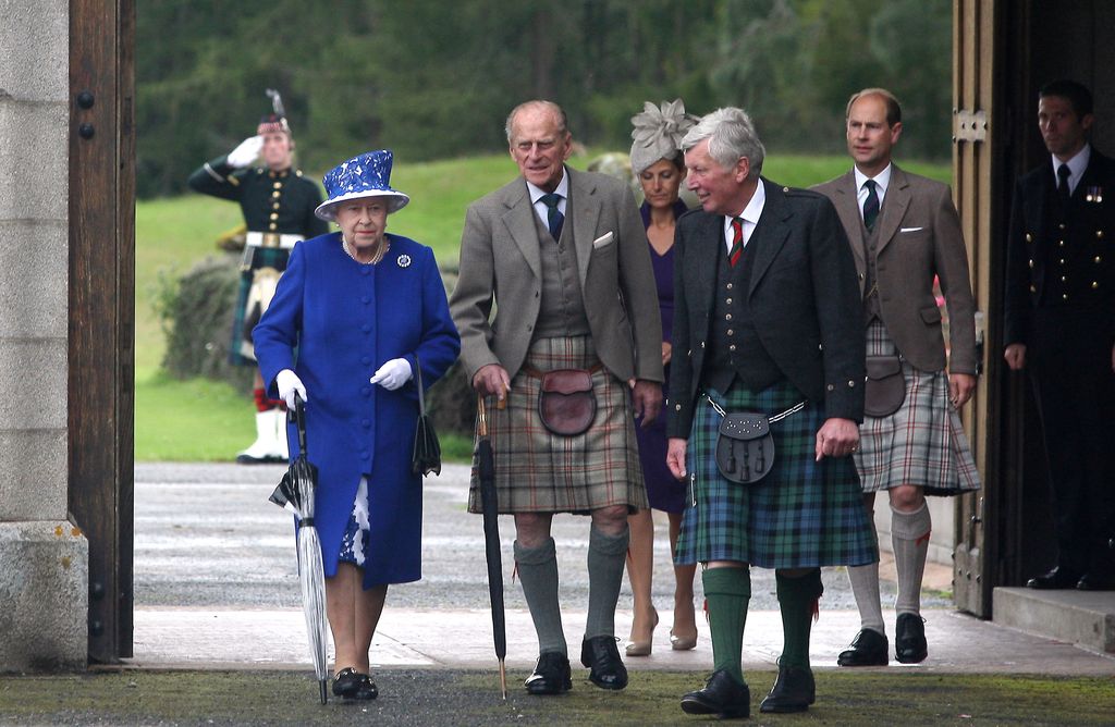 Queen Elizabeth II and Prince Edward,  Earl of Wessex walk with Prince Philip, Duke of Edinburgh (2nd left) on August 07, 2012 in Aberdeenshire, United Kingdom.