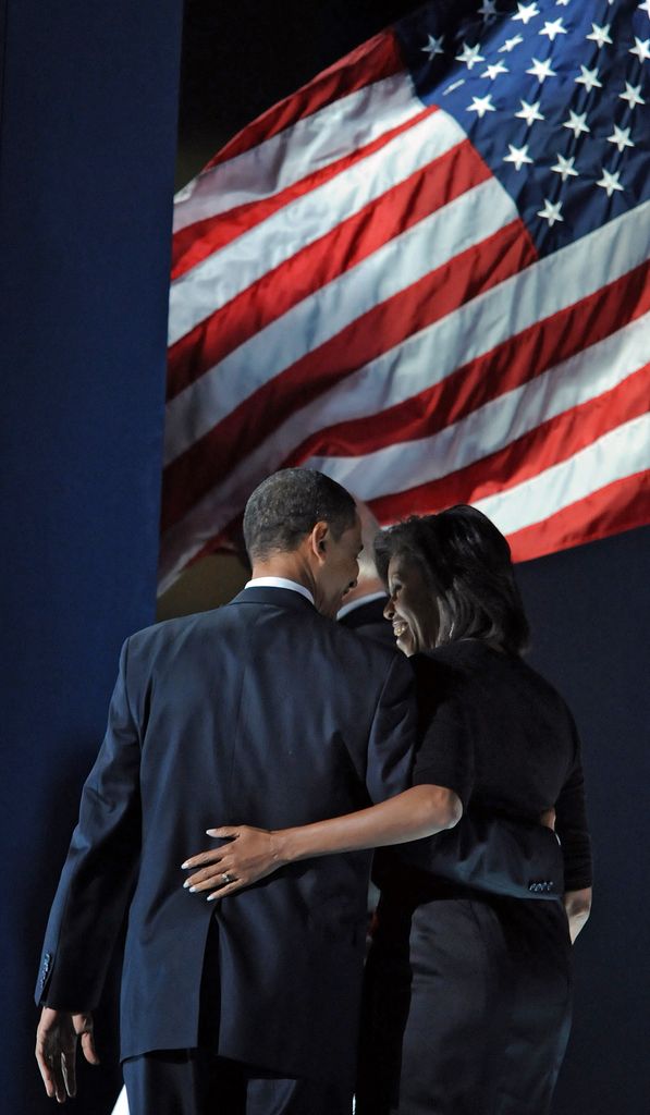 Barack Obama and his wife Michelle depart the stage after Obama addressed supporters in his election night victory rally at Grant Park on November 4, 2008 in Chicago, Illinois