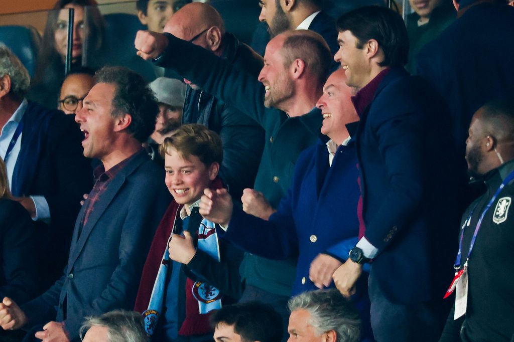 George and William punching air at football match