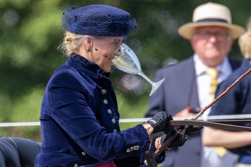 Duchess Sophie carriage driving while holding a glass between her teeth