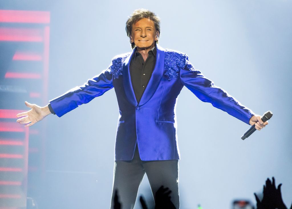 photo of barry manilow holding mic on stage