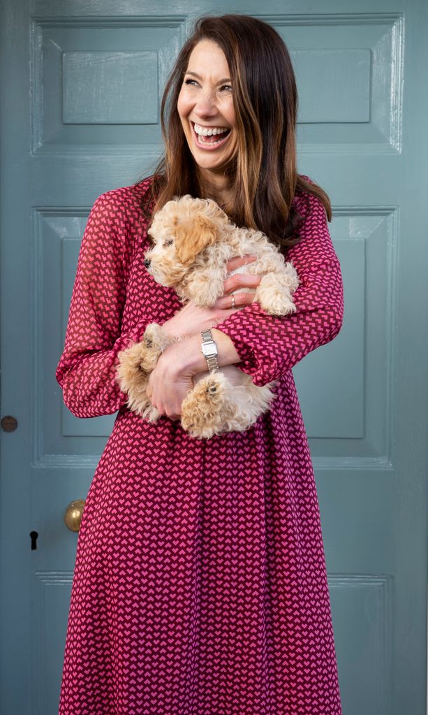 woman cuddling a puppy