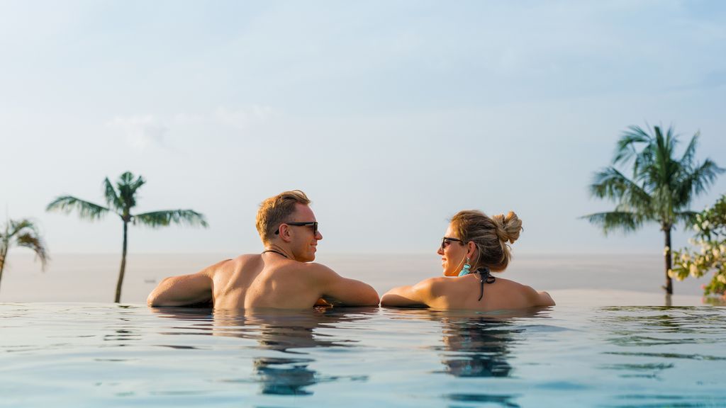 couple in infinity pool on holiday