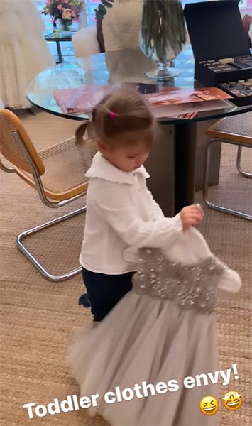 Rachel Rileys daughter playing with a dress