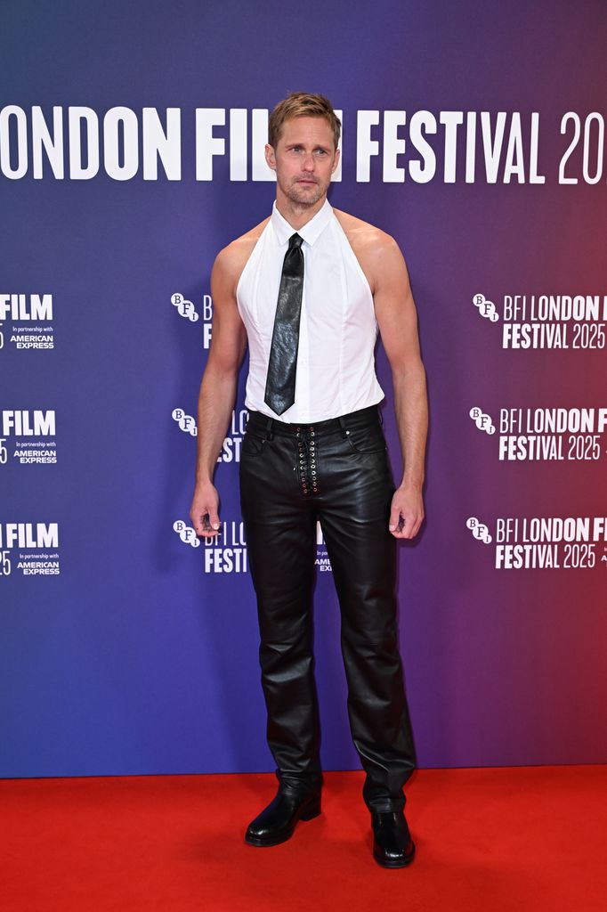 Alexander Skarsgard on red carpet in white shirt and black tie