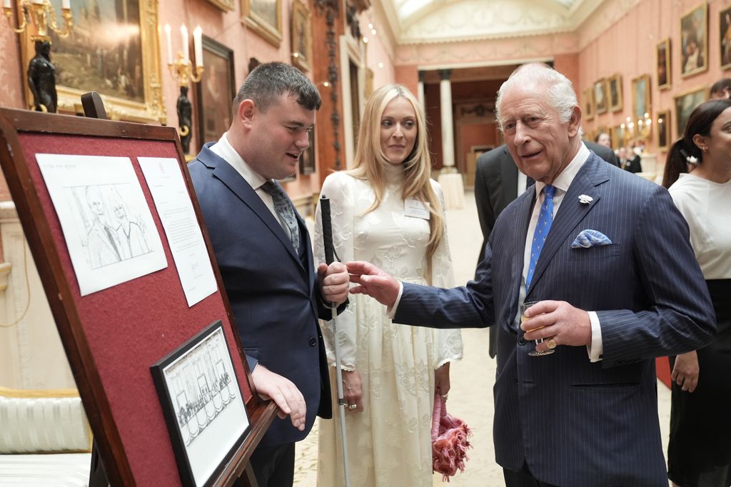 King Charles III speaks with award winner Brendan Hulcoop as Fearne Cotton watches on 