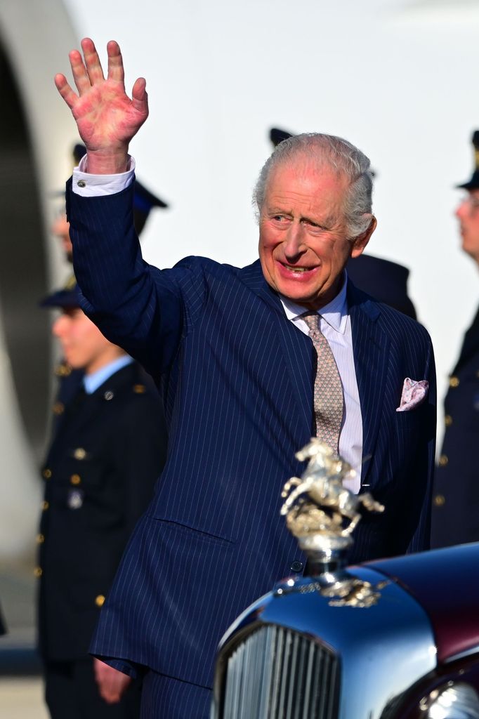 king charles waving navy suit