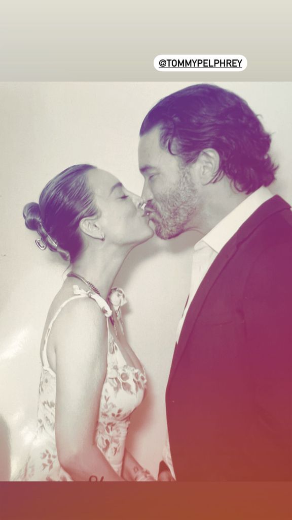 Kaley Cuoco and Tom Pelphrey kissing in a black and white photo