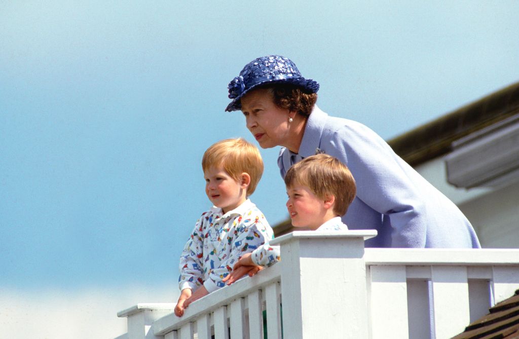 The Queen watches the polo with William and Harry in the royal box