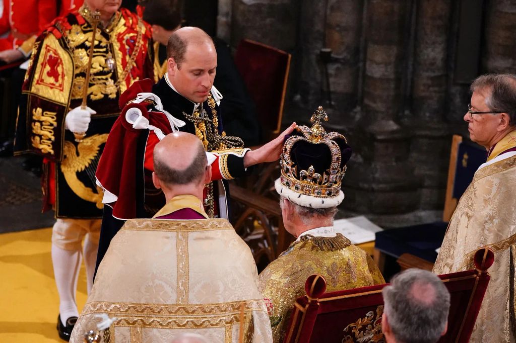 Prince William touches the crown on King Charles' head at the coronation 