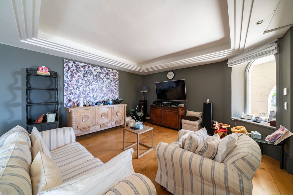 Interior shot of family room with TV and sofas plus artwork on walls