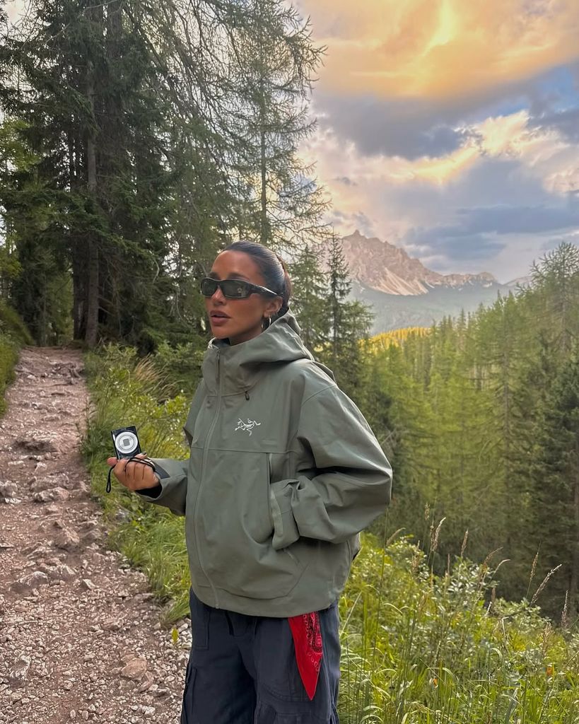 Parisa wearing green waterproof jacket and sunglasses