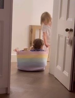 Robbie Williams children Coco and Beau playing in laundry basket