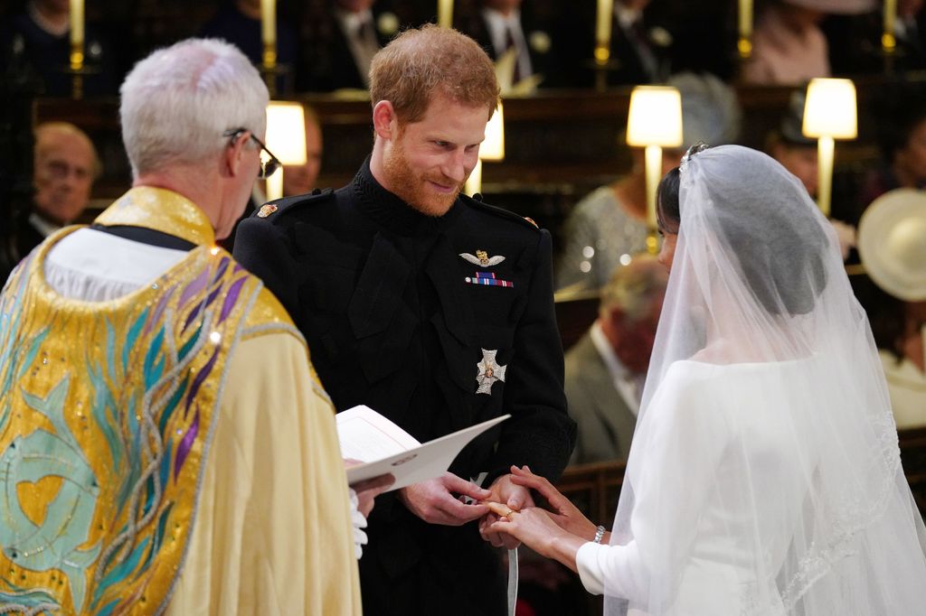 Prince Harry and Meghan Markle exchanging rings