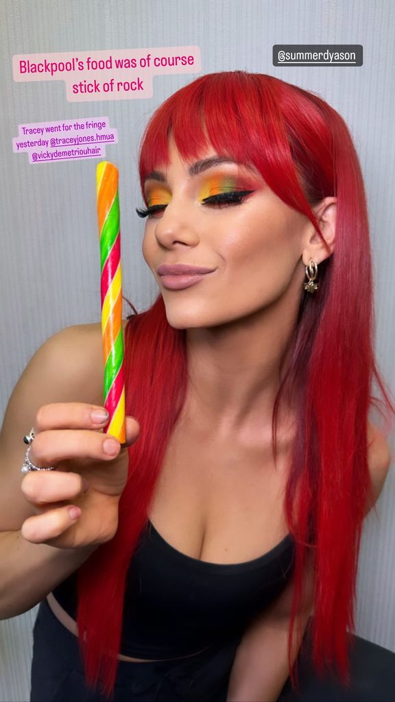 Dianne Buswell posing with a stick of rock
