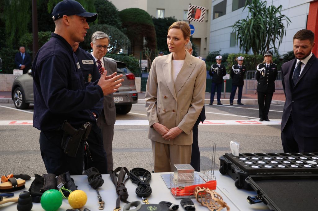 Princess Charlene of Monaco (C) and her brother Gareth Wittstock (R) attend the presentation ot the canine brigade in The Principality of Monaco on October 27, 2025. The princess is the initiator of the creation of the canine brigade and she is president of SPA Monaco (Societe Protectrice des animaux) (Photo by Valery HACHE / AFP) / / NO TABLOIDS WEB & PRINT, NO DAILY MAIL, NO DAILY MAIL GROUP, NO VOICI, NO CLOSER (Photo by VALERY HACHE/AFP via Getty Images)          