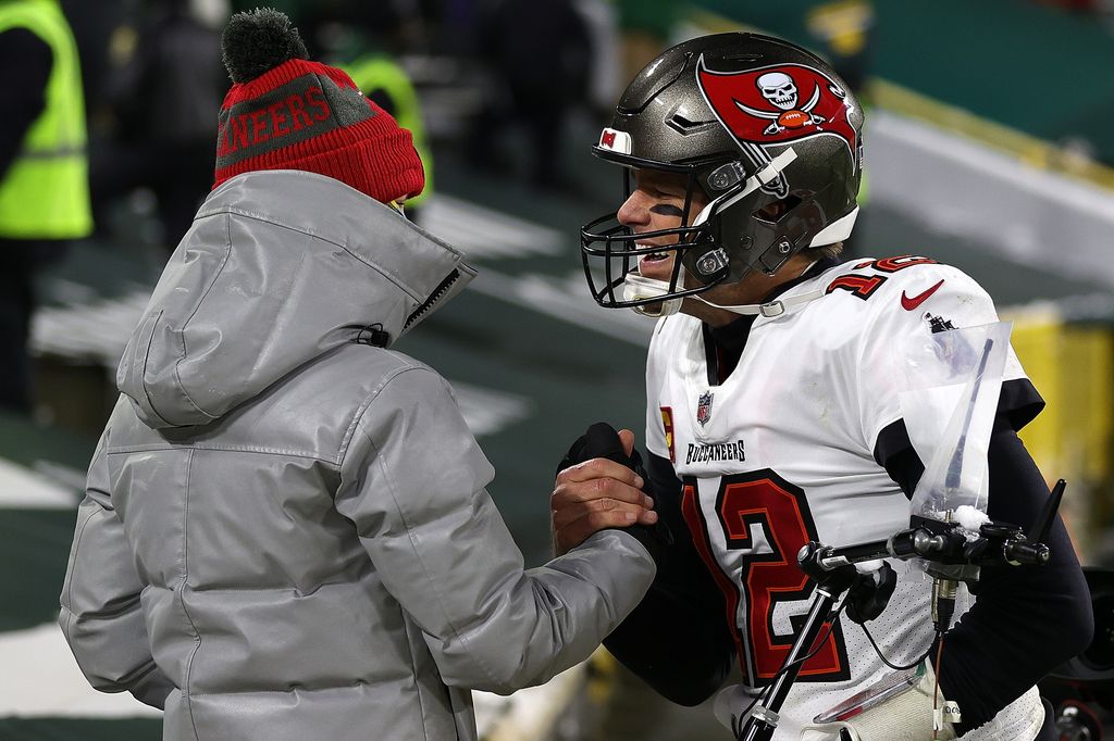 Tom Brady #12 of the Tampa Bay Buccaneers greets his son Jack following their victory over the  Green Bay Packers in the NFC Championship game at Lambeau Field on January 24, 2021 in Green Bay, Wisconsin. The Buccaneers defeated the Packers 31-26. 