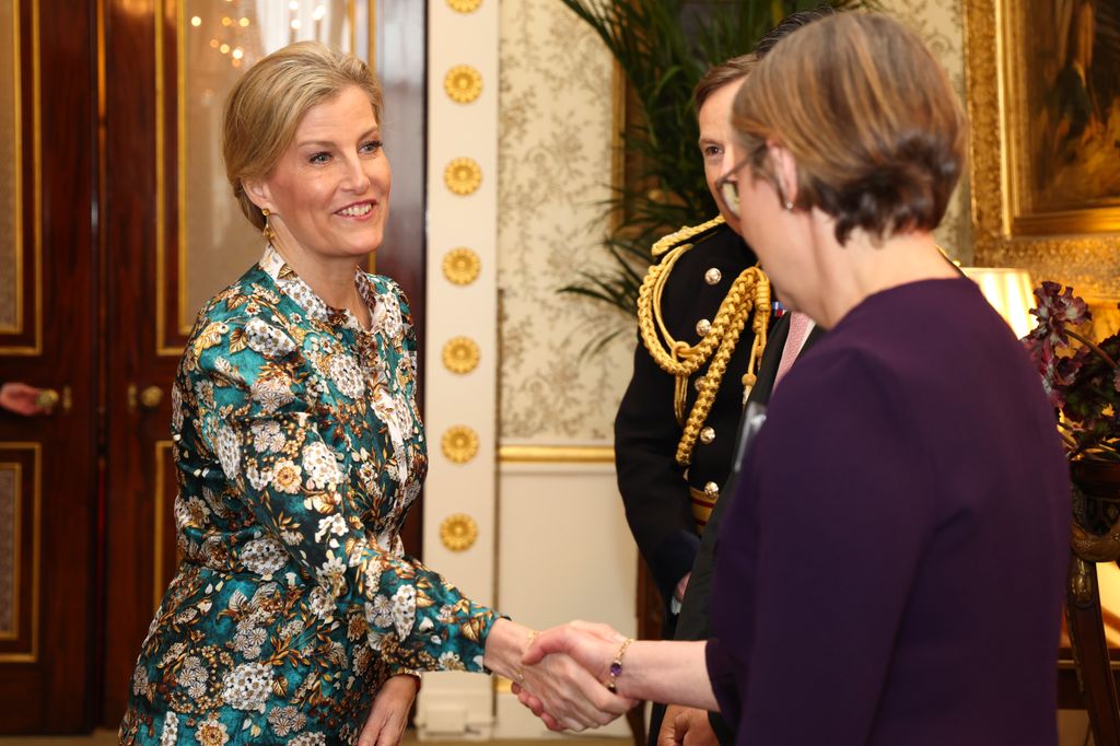 The Duchess of Edinburgh shakes hands with the Director of Remembrance Philippa Rawlinson  during a reception for Korean war veterans