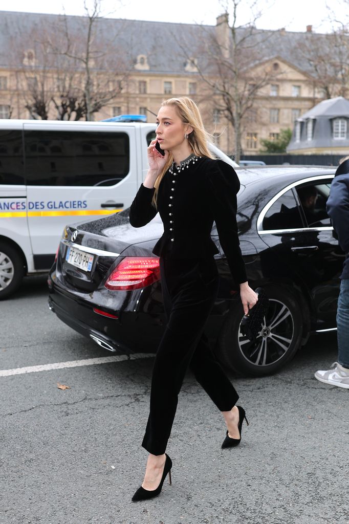 Beatrice Borromeo wore a structured black velvet jumpsuit with pearl accents, a clutch, and sleek heels, delivering effortless elegance on the streets of Paris.