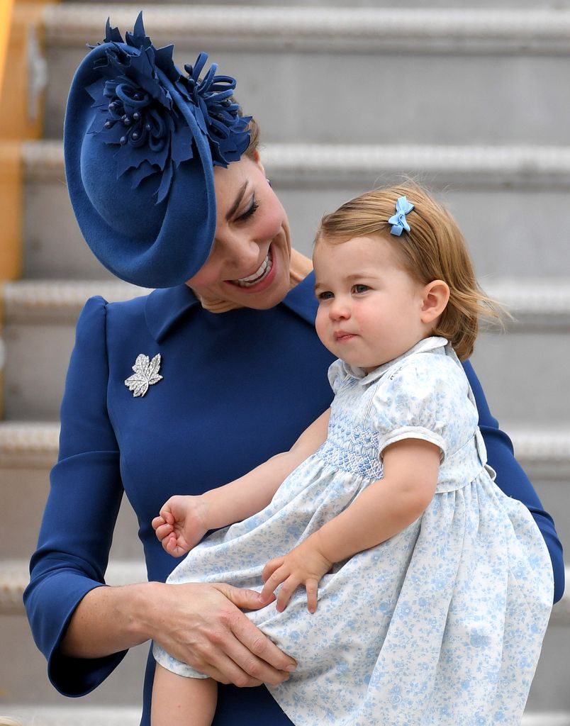 Princess Kate holding a baby Princess Charlotte