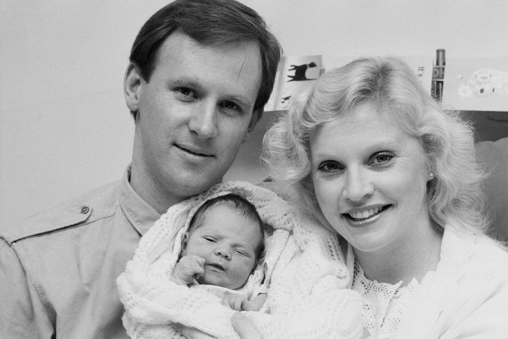 Black and white photo of Peter Davison, Sandra Dickinson and a baby