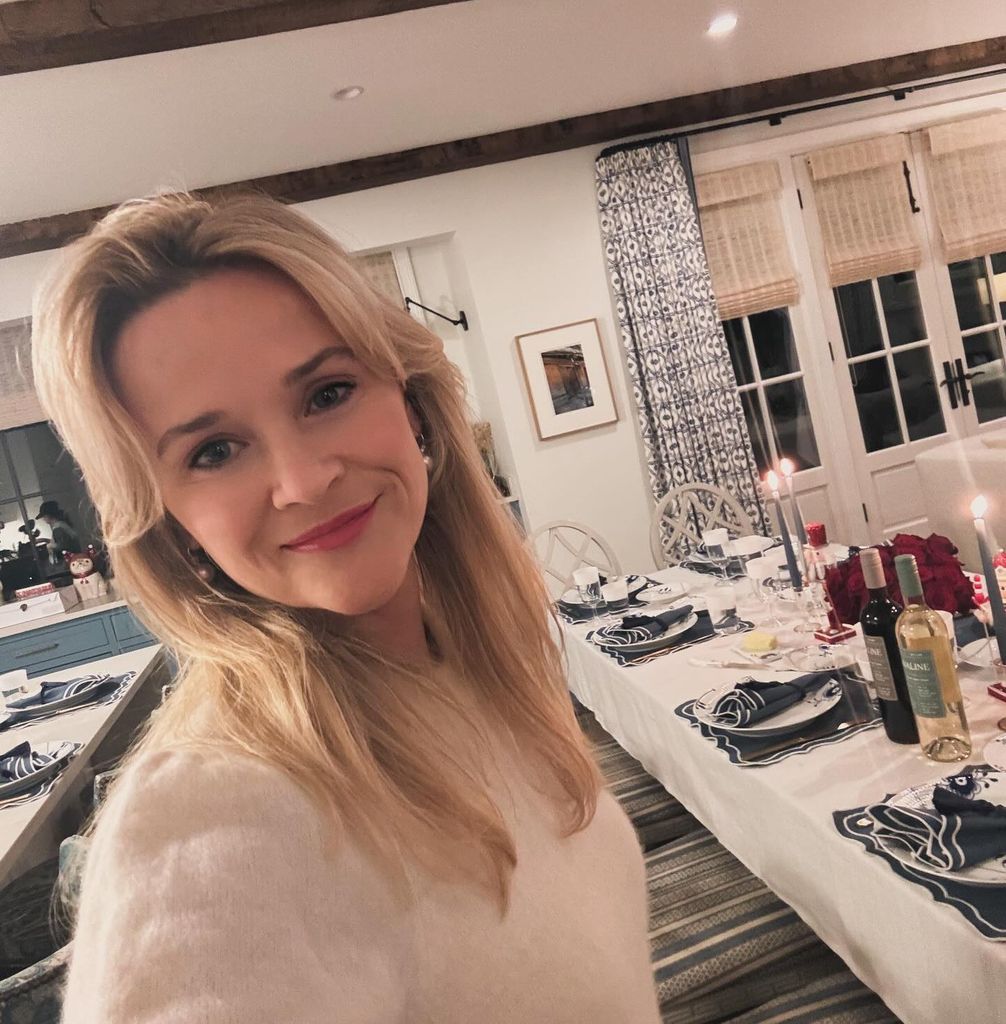Reese Witherspoon taking a selfie in front of her Christmas decor