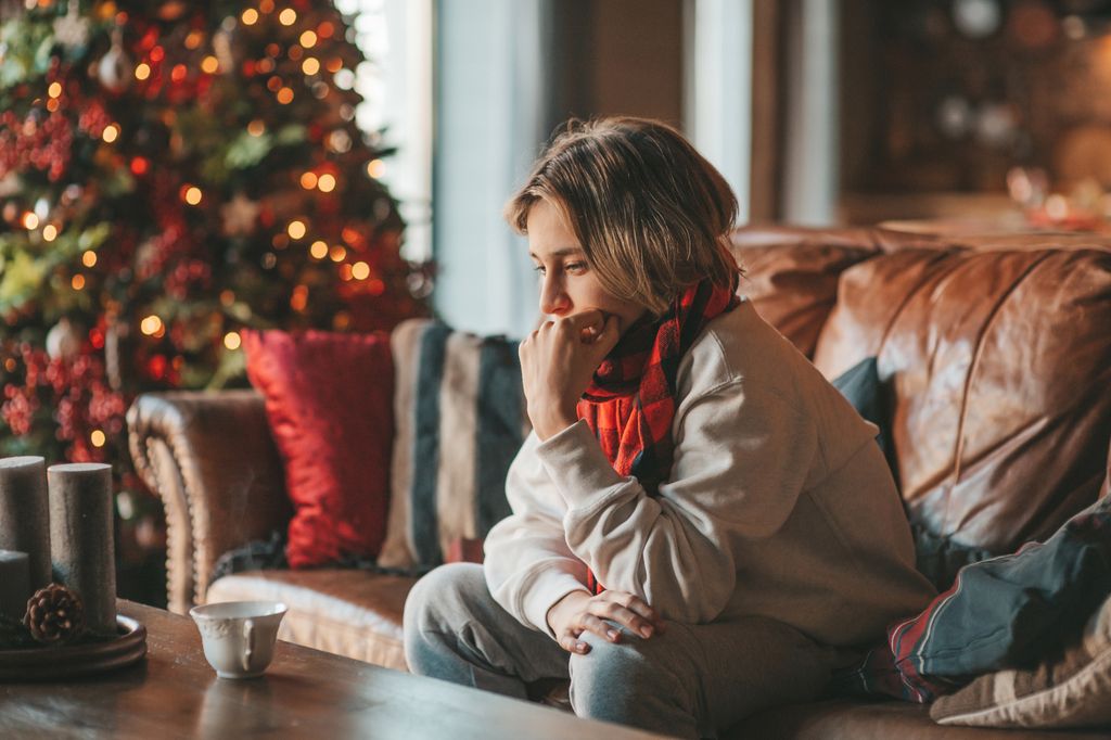 Young teen boy with long hair thoughtful look sad eyes negative mood angry