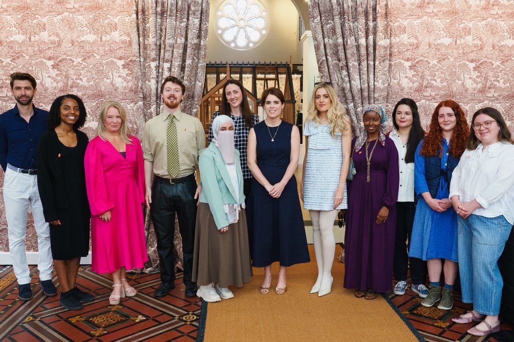 Princess Eugenie poses with a group of people